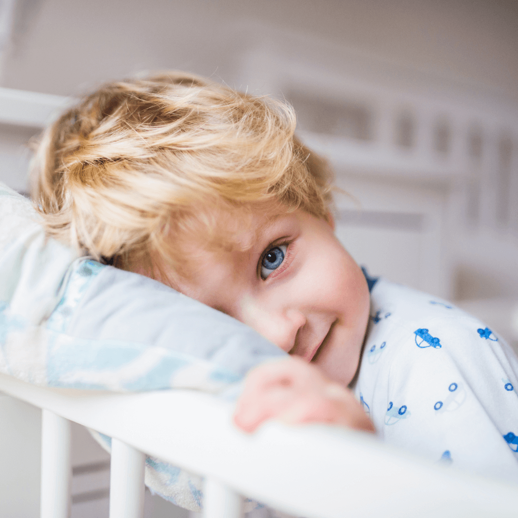 Toddler in cot